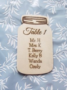 an embroidered table number is shown on a blue and white background