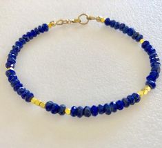 Gold Lapis Lazuli Beaded Bracelets With Round Beads, Gold Lapis Lazuli Bracelet With Gemstone, Gold Lapis Lazuli Gemstone Bracelet, Sapphire Beaded Bracelets With Faceted Beads For Gift, Gift Sapphire Beaded Bracelets With Faceted Beads, Gold Beaded Lapis Lazuli Bracelets, Gold Lapis Lazuli Spiritual Bracelets, Hand-strung Gold Lapis Lazuli Bracelets, Handmade Gold Beaded Lapis Lazuli Bracelets