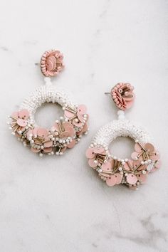 Glitz up your OOTD by accessorizing with our white "Spring Up" statement earrings featuring beaded circles with flowers on the centers that connect to form a dangling teardrop! Final Sale Spring Accessories Beaded Blush/White Wedding Accessories Colors May Vary Patterns May Vary White Beaded Earrings, Textile Earrings, June Bride, Earring Inspiration, Fabric Jewellery, Decor Videos, Wedding Day Jewelry, Spring Accessories, Bride Earrings