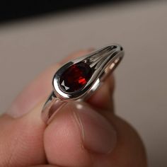 This is a gorgeous handmade creation. Its beauty is its simplicity & Elegance. The 5*7 mm oval shape faceted natural garnet is crafted in solid sterling silver and with rhodium plated. All item is sent in a beautiful gift box If you have any idea of design your ring,pls contact me directly. You can realize more lovely stuff clicking the link https://www.etsy.com/shop/knightjewelry?refshopsection_shophome_leftnav Please leave the correct address and you phone number for delivering successfull Oval Garnet Ruby Ring As Gift, Oval Garnet Birthstone Ring As Gift, Silver Oval Garnet Birthstone Ring, Oval Silver Garnet Birthstone Ring, Oval Cabochon Garnet Rings For Anniversary, Oval Garnet Birthstone Ring In Silver, Oval Garnet Birthstone Ring For Anniversary, Oval Faceted Ruby Ring For Anniversary, Oval Garnet Birthstone Ring