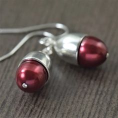 Ruby Red freshwater pearl earrings featuring a domed sterling silver crown. The earrings dangle freely from lightweight sterling silver earwires. South Paw, Pearl Birthstone, Murano Glass Jewelry, Ruby Birthstone, March Birthstone Jewelry, Freshwater Pearl Earrings, Pearl Dangle Earrings, Silver Crown, Summer Earring