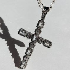 Introducing the exquisite Hope CZ Cross Necklace - a timeless symbol of faith and style. This stunning piece features a Large White Gold CZ Cross on a Sterling Silver Flat Figaro chain. This necklace is a must in your jewelry collection for all trendy & aesthetic wearers. Product Details: 16" 3.5mm Sterling Silver Flat Figaro Chain 60mm 24K White Gold CZ Cross Charm Not Water-Wearable Made in Scottsdale, AZ Diamond Cross Pendant Jewelry With Bling, Elegant Silver Cross Necklace With Cubic Zirconia, Luxury Cross-shaped Diamond Jewelry, Elegant Cubic Zirconia Cross Necklace With Clavicle Chain, Spiritual Cubic Zirconia Necklaces With Diamond Accents, Diamond White Cross-shaped Diamond Jewelry, White Gold Cross Jewelry For Spiritual Style, Spiritual White Gold Cross Jewelry, Crystal Clavicle Chain With Cross Pendant