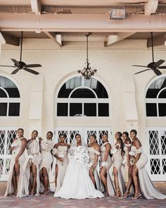 a group of women standing next to each other in front of a building