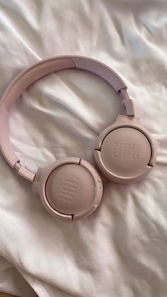 a pair of headphones laying on top of a bed