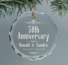 an ornament hanging from a christmas tree with the words 50th anniversary on it