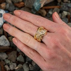 This incredible Stephanie Occhipinti 14K yellow gold ring is topped with 22K yellow gold leaf motifs. The ring is accented with forty-two (42) round brilliant cut diamonds set into five-channels. The ring measures 17.1mm at the top, rises 5.2mm above the finger, tapering to 8.9mm wide and 1.7mm thick at the base of the shank. This ring is currently a size 10. Wide Band Diamond Rings, Band Diamond Ring, Yellow Gold Ring, Size 10 Rings, Wide Bands, October Birth Stone, Brilliant Diamond, 22k Gold, Round Brilliant Cut Diamond