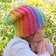 a young child wearing a multicolored crocheted hat