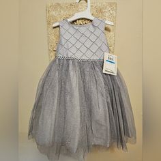 >Genuine Marmellata Dress - 2 Pc Set >New With Tags - Never Worn - Groom Called Off Wedding! >Beautiful Silver Dress With Sparkling Toulle Overlay And Bloomers (Diaper Cover) >Fully Lined Quality Dress >Built-In Petticoat For Added Pouf! >Sparkly Braided Waist >Toddler Size 24 Months >Your Little One With Sparkle And Dazzle In This Dress! Elegant Sleeveless Tutu Dress For Festive Occasions, Elegant Festive Tutu Dress For Party, Elegant Festive Tutu Party Dress, Elegant Festive Party Tutu Dress, Silver Princess Dress For Dress-up, Elegant Silver Dresses For Formal Occasions, Silver Dresses For Spring Festivities, Silver Festive Dress For Holidays, Silver Holiday Dresses For Festive Occasions