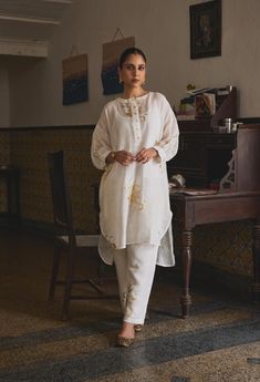 Pristine, elegant, and chic, the Manmohini Co-ord Set is perfect for the woman who swears by understated luxury. As gold florals peek out this gauze linen set and dainty buttons add a delicate regal touch, you can be assured of maximum comfort without any compromises on the style. MODEL DETAILS Model Name-Raghvi Sehgal  Bust- 32.5  Arms- 10.9  Hips-37  Height - 5.6 Fabric: 100% Gauze Linen Characteristics of Linen : Hygroscopic All Natural UV Protection Kind On Skin Naturally Breathable Strong Improves With Age Handmade With Love In India By Yell Retail India. Chic Festive Eid Sets, Chic White Festive Sets, Chic Festive White Sets, Elegant Chikankari Embroidered Palazzo Set For Summer, Elegant Sets With Chikankari Embroidery For Summer, Elegant Chikankari Embroidery Palazzo Set For Summer, Elegant Summer Sets With Chikankari Embroidery, Elegant Chikankari Embroidery Sets For Summer, Chic Wedding Sets For Eid