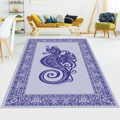 a blue and white rug with an image of a dragon on the floor in front of a couch