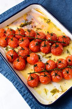 tomatoes are arranged on top of cheese in a baking dish