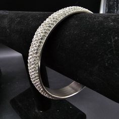 This stainless steel pave rhinestone bangle bracelet fits up to a 9" wrist Party Jewelry With Rhinestones In Stainless Steel, Metal Round Bracelet With Rhinestones, Metal Bracelet With Rhinestones, Metal Round Bracelets With Rhinestones, Metal Bracelets With Rhinestones, Metal Bangle With Rhinestones For Gift, Sparkling Metal Bangle Crystal Bracelet, Metal Bangle With Rhinestones As Gift, Sparkling Metal Crystal Bangle Bracelet