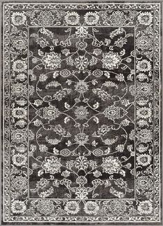 a black and white rug with an ornate design on the bottom, in front of a gray background