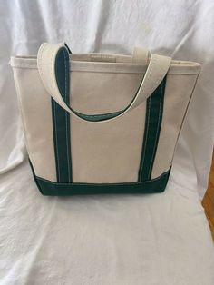 ll bean boat and tote bag small 9.5 tall, 10 wide green trim EUC. Classic heavy weight canvas tote with hunter green trim and bottom. Perfect to use as an alternate Easter basket! Green Canvas Bag With Double Handle, Green Double Handle Canvas Bag, Casual Green Canvas Bag With Double Handle, Green Bucket Canvas Bag For Travel, Green Duck Canvas Bag For Daily Use, Green Bucket Canvas Bag For Everyday Use, Green Duck Canvas Travel Bag, Green Daily Bucket Canvas Bag, Green Duck Canvas Bag For Everyday Use