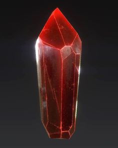 a large red crystal standing on top of a table