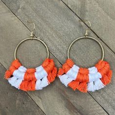 Show your University of Tennessee Team Spirit! This pair of beautiful macrame earrings were hand knotted and fringed at the edges with orange and white cotton cord.  These are very lightweight to wear and have nickel free 14k gold plated earring wires. Each round shaped earring is 2 1/2 inches long and about 2 1/2 inches wide.  Be sure to check out the rest of my micro-macrame jewelry in the shop! Tennessee Earrings, Large Statement Earrings, Earring Wires, Macrame Earrings, Spring Hill, University Of Tennessee, Micro Macrame, Macrame Jewelry, White Earrings