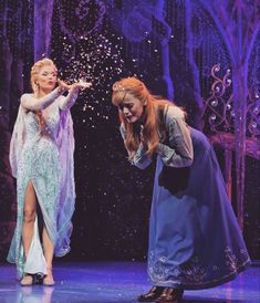 two women dressed as frozen princesses on stage