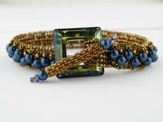 two bracelets with blue beads and green glass beads