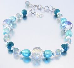 "A gorgeous addition to your jewelry collection, I made this elegant bracelet with 9x11 aqua rainbow crystal glass, 8mm teal freshwater pearls, 6mm rainbow crystal glass, 6x8mm faceted dark teal glass beads with silver tone spacers and findings. Choose your size: Small - 5 1/2\" - 6 1/2\" Medium - 6 1/2\" - 7 1/2\" Large - 7 1/2\" - 8 1/2\" This bracelet is strung on super strong Beadalon 49 strand wire. Due to variances in stones, bracelet received will be similar to bracelet shown. Please cont Elegant Turquoise Aquamarine Beaded Bracelets, Elegant Turquoise Crystal Bracelet With Spacer Beads, Elegant Aquamarine Beaded Bracelets, Elegant Turquoise Crystal Bracelet With Faceted Beads, Elegant Turquoise Czech Glass Beaded Bracelets, Elegant Turquoise Crystal Bracelet With Round Beads, Teal Glass, Beaded Ankle Bracelets, Green Beaded Bracelets