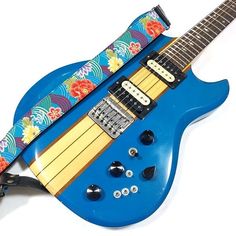 a blue electric guitar with flowers on it