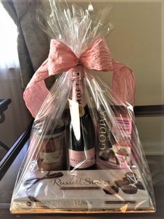 a bottle of wine and chocolates wrapped in plastic