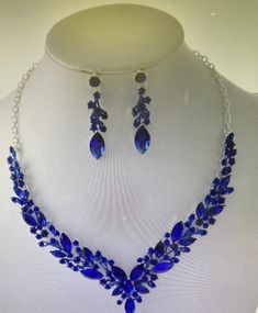 Approx. Necklace Size: 16.5" plus3"L EXT post earring: 2"Lx0.4"W Blue Crystal Jewelry With Rhinestones, Elegant Blue Crystal Rhinestone Necklace, Blue Rhinestone Jewelry Sets For Formal Occasions, Formal Blue Jewelry Sets With Rhinestones, Blue Rhinestone Jewelry Sets For Gift, Sapphire Metal Jewelry For Party, Sapphire Party Jewelry, Blue Crystal Rhinestone Necklace For Wedding, Blue Party Jewelry Sets With Rhinestones