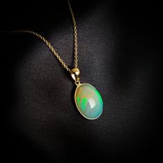 This stunning Pendant is set in 14k Solid Yellow Gold with Natural Ethiopion White Opal with utmost precision. It is a unique gemstone Pendant for nearly every occasion and is completely hassle-free jewelry. ITEM DETAILS: * GEM: White Opal * GEM SIZE: 12.5X15mm * GEM SHAPE: Oval * Gem weight: 4.03 carats * Gold Purity: 14KT  * Gold Weight: 0.55 gram * Total Weight of the Pendant: 1.34 gram The Gold purity is guaranteed and it comes with authentic 14KT gold hallmark. Since my items are handmade, Oval Ethiopian Opal Anniversary Jewelry, Oval Ethiopian Opal Birthstone Jewelry, 14k Gold Jewelry With Cabochon For May Birthstone, 14k Yellow Gold Gemstones For Gift, Oval Yellow Gold Jewelry With High Luster, Round Ethiopian Opal Jewelry For Gift, Oval Yellow Gold High Luster Jewelry, Round Ethiopian Opal Jewelry Gift, Yellow Gold Gemstones For Gift, Fine Jewelry Style