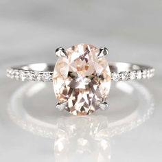 an oval cut peach morganite ring with diamond accents