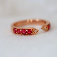 This ring features red spinels and diamonds with the most fascinating red color. The size 6.75 ring is made of solid 18K gold can be sized up or down for $65 if needed. This item is brand new and was appraised by a gemologist. The certificate will be included and describes the spinel as follows: Condition: Brand New & Custom Designed by me  Size: US 6.75 sizable  Metal: Solid 14K Rose Gold  Center Stone: Vivid Red Spinels 0.62ct.  Side Stones: Earth Mined Diamonds 0.05ct  Measurement: 4mm front Red Open Diamond Promise Ring, Luxury Red Diamond Ring With Single Cut Diamonds, Red Ruby Open Diamond Ring, Red 14k Gold Birthstone Ring For Promise, Red Diamond Ring With Rose Cut Lab-created Ruby, Red Gemstone Diamond Ring, Open Ring Style, Red Gemstone Open Diamond Ring, Red Ruby Birthstone Ring In Fine Jewelry Style, Fine Jewelry Red Ruby Birthstone Ring