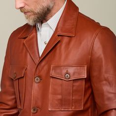 This rugged Safari Leather jacket is a vintage look that is sure to keep you warm while you brave the cold. Adorned with two upper pockets and two lower pockets, this piece enables you to pack as heavy or light in the cold as you like. Layer this Safari Jacket with a lightweight sweater or simple button down to achieve a dynamic look of western sophistication. Model is 6'1 and wearing size M. Winter Brown Sport Coat With Patch Pockets, Brown Fall Sport Coat With Patch Pockets, Brown Sport Coat With Patch Pockets For Winter, Brown Sport Coat With Patch Pockets For Fall, Masculine Outerwear With Pockets For Work, Brown Leather Jacket With Patch Pockets, Brown Outerwear With Patch Pockets And Lapel Collar, Masculine Winter Outerwear With Pockets, Long Sleeve Outerwear With Pockets For Hunting