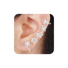 a woman's ear with three stars on it