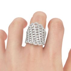 a woman's hand with a diamond ring on top of her finger, and the middle