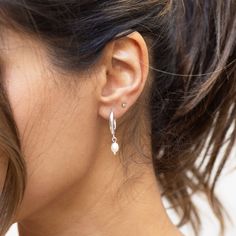 Introducing our pendant hoop earrings, featuring a dainty fresh water pearl charm. An exclusive dangle hoop earring design, comprised of quality, water- resistant 18k silver plated stainless steel. Also available in gold. Please note we do not accept exchanges or returns on earrings for hygiene reasons. Shop more empowering jewellery and luxury homeware on our store: https://www.etsy.com/uk/shop/NikitaByNiki MATERIALS: Base: Hypoallergenic nickel free 316L stainless steel. Plating: Genuine 18k s Dangly Silver Earrings, Dangly Earring, Dangle Hoop Earrings, Freshwater Pearls Earrings, Waterproof Jewelry, Pearl Hoop Earrings, Fresh Water Pearl, Dangly Earrings, Pearl Charms