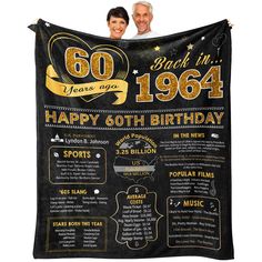 an old man and woman holding up a 50th birthday blanket