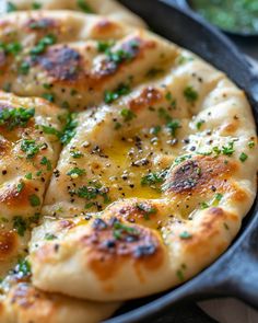 a pizza sitting on top of a pan covered in cheese and parsley toppings