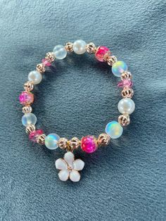 Our Flower Power bracelet is handmade with love  Each of our bracelets are lovingly handmade and are set with positive intentions 🤍  Our Flower Power bracelet includes beautiful cerise pink & gold two tone crystal beads, natural raw cut gemstones and mesmerising moonstone crystal beads. Finished with a gorgeous white and rose gold flower charm 🤍  This is the perfect gift for yourself & loved ones, to capture the beauty of nature & take it with you wherever you may roam  As our bracelets are be Bohemian Pink Beaded Pearl Bracelet, Handmade Rose Gold Spiritual Beaded Bracelets, Pink Charm Bracelet With 8mm Beads, Pink Beaded Charm Bangle Bracelet, Pink Beaded Bangle Charm Bracelet, Beaded Pink Gold Bracelets For Gift, Adjustable Pink Charm Bracelet With Spacer Beads, Pink Gold Beaded Bracelets As Gift, Pink Gold Beaded Bracelets For Gift