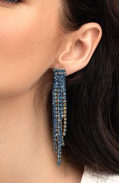 Add a sway of sparkle to lots of looks with these captivating earrings that feature sparkling blue crystals. 3 5/8" drop; 3/8" width Post back Glass/goldtone plate Imported Blue Dangle Crystal Earrings For Evening, Blue Rhinestone Earrings For Evening, Blue Crystal Chandelier Earrings For Party, Blue Jeweled Dangle Crystal Earrings, Blue Jeweled Crystal Earrings For Party, Blue Crystal Rhinestone Earrings, Glamorous Blue Drop Earrings, Glamorous Blue Crystal Earrings For Party, Blue Rhinestone Dangle Earrings