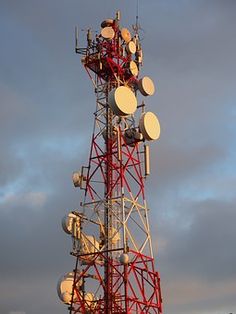 a tall tower with several different types of antennas