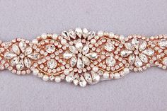 This gorgeous rhinestone & pearl bridal belt will definitely add a touch of sparkle and glamour to bridal or bridesmaid dress! Get this beautiful wedding belt sash for your wedding day! ♥ APPLIQUE SIZE: The rhinestone applique part is about 22 ” inches Long; 2” inches at widest center Elegant Gold Bridal Belt For Bridesmaids, Elegant Gold Bridal Belt For Bride, Wedding Dress Belt Rose Gold, Gold Beaded Bridal Belt For Party, Gold Crystal Bridal Belt For Party, Elegant Pink Bridal Belt For Wedding, Elegant Gold Bridal Belt With Sashes, Bridesmaid Belt, Embellished Belt