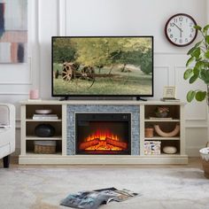 a living room with a large television and fireplace