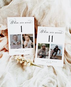 two wedding cards with the same photo on them sitting on a bed next to a flower