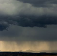 an airplane is flying in the sky with storm clouds