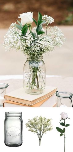 a vase filled with white flowers sitting on top of a table next to two candles