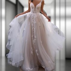 a woman in a wedding dress walking down a hallway