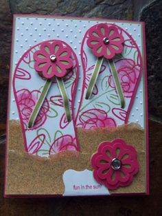 a close up of a card with two flowers on the front and one flower on the back