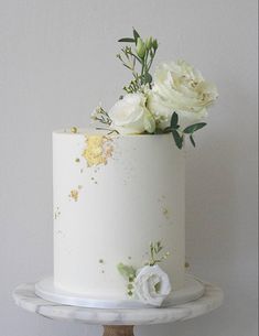 there is a white cake with flowers on it