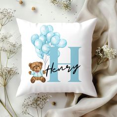 a pillow with a teddy bear and balloons on it that says h is for henry