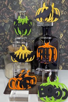 halloween decorations are displayed on display in front of a wall with black and orange paper