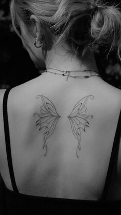 a woman with a butterfly tattoo on her back