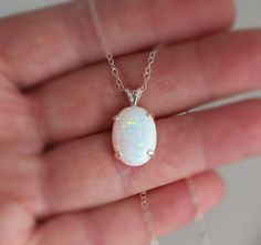 "Beautiful Large white lab-created opal pendant necklace. These gorgeous opals are very similar to natural mined opals. Lab-created opals contain 70-90% silica (from which natural opal is formed) and 10-30% resin. The resin makes the opal harder, stronger, unlike natural opals, which are known to be soft and fragile. Each opal displays a rainbow of color that sparkles with every catch of light. I've handset two different size opals in a solid sterling silver prong settings 16x12mm (5/8\" x 1/2\" White Opal Birthstone Jewelry, Elegant White Pink Opal Jewelry, White Pink Opal Gemstone Jewelry, White Ethiopian Opal Gemstone Necklace, White Opal Gemstone Necklace, White Ethiopian Opal Gemstone Jewelry, White Opal Round Pendant Necklace, White Opal Pendant Jewelry, White Opal Necklace For Gift